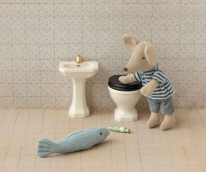 Miniature bathroom, suitcase house, and mouse house.